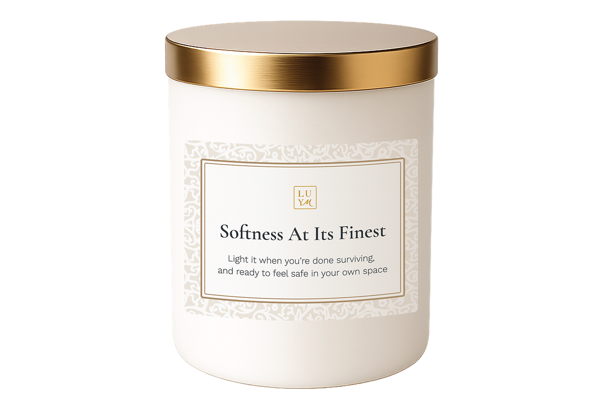 A fresh lilac floral candle burning gently, creating a safe space ritual for deep rest and nervous system care.